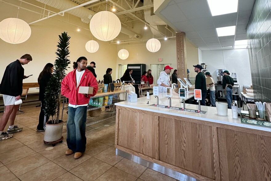 Slow Rise customers make their way through a line the brand’s new shop in St. Andrews Plaza, 11228 W. 135th St. in Overland Park.