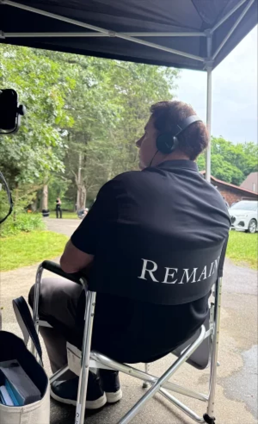 Nicholas Sparks is shown watching the set of Remain, a film and novel project he developed with M. Night Shyamalan.