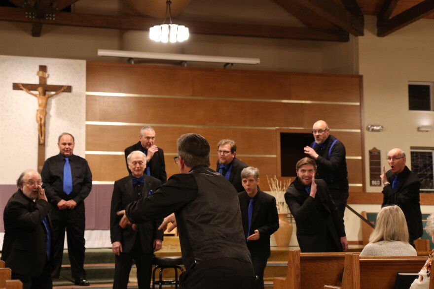 Director, Mark Slamka, leads the Barbergators in a performance at St. Patrick Church. (Nicole Beltran/WUFT News)