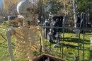A skeleton stands before a graveyard Oct. 19, 2026, in the ever-expanding Halloween display created by Jeffrey Broking alongside family members on Crystal Springs Loop, south of Grand Rapids.