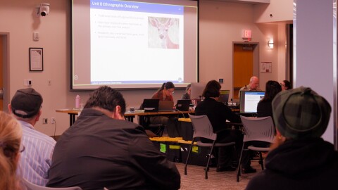 The 7-member Board of Game listens to a presentation on Sitka black-tailed deer in Unit 8, while members of the public look on.