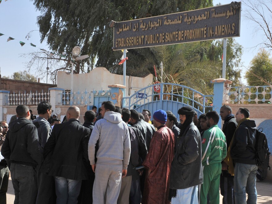 People gather Friday outside a hospital in eastern Algeria as they try to get information on those wounded during a military raid on a gas plant where Islamic extremists were holding hostages.