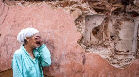 A woman reacts standing in front of her earthquake-damaged house in the old city in Marrakesh on Saturday.