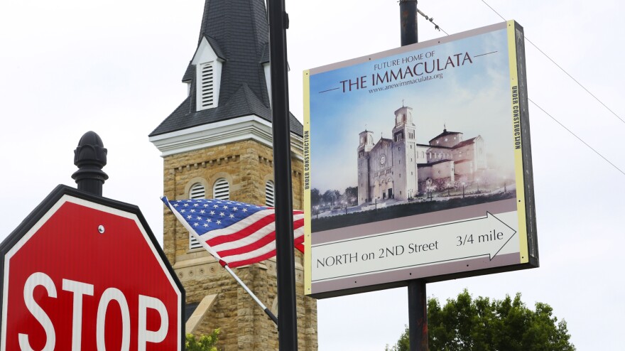 A sign in the center of St. Marys advertises the location of the Immaculata, a towering structure just a few streets away.