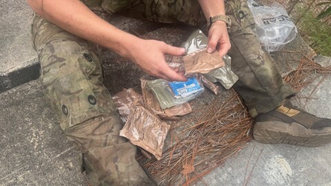 A Special Operations solider at Fort Bragg, N.C. digs into a Close Combat Assault Ration, the military's newly introduced meal for troops in the field.