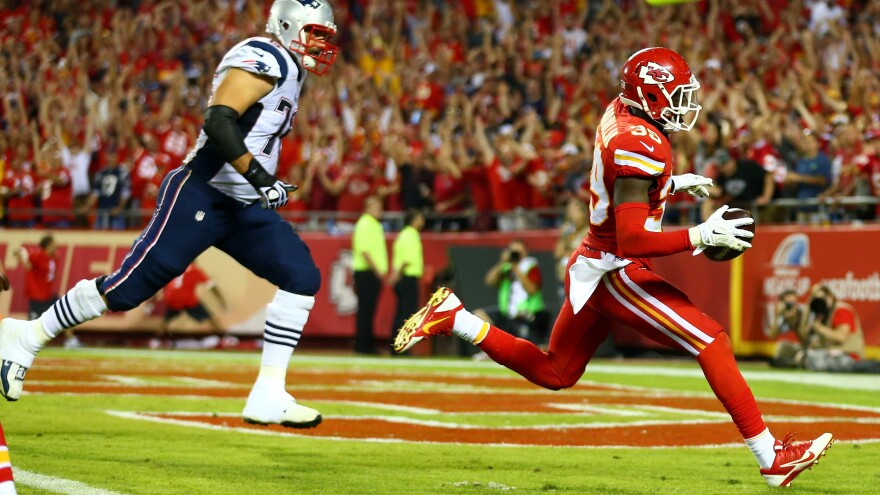 Husain Abdullah of the Kansas City Chiefs scores a touchdown after an interception against the New England Patriots Monday. He was then penalized for praying on his knees — something the NFL now says shouldn't have been punished.