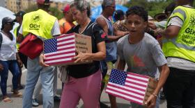 People affected by the earthquakes carry U.S. humanitarian aid after receiving it in La Guaira, Venezuela, Wednesday, July 8, 2026. 