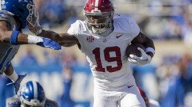 Alabama wide receiver Kendrick Law (19) stiff arms Kentucky defensive back Ty Bryant (14) during the first half of an NCAA college football game in Lexington, Ky., Saturday, Nov. 11, 2023. (AP Photo/Michelle Haas Hutchins)