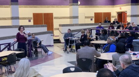 Board member Jocelyn Rhynard address the crowd at a town hall meeting at Thurgood Marshall High School on Thursday, March 21. 