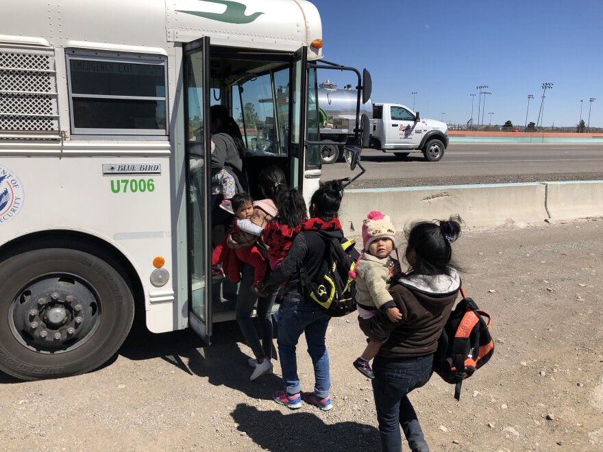 Migrants crowd into a waiting Border Patrol bus after turning themselves in at the border. They will be taken into custody while their asylum cases are processed.