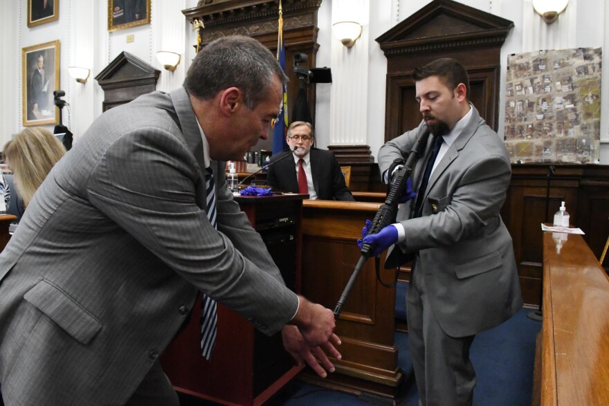 Defense attorney Mark D. Richards uses Kyle's gun held by Kenosha police detective Mark Howard as he cross examines Dr. P. Douglas Kelley of the Milwaukee County Medical Examiners Office about the possible position of Joseph Rosenbaum when he was shot and killed, during the Kyle Rittenhouse trial in Kenosha Circuit Court Tuesday.