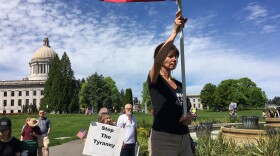 Participants at the Saturday rally prayed as the event got underway. Government overreach and tyranny were common themes. CREDIT: Austin Jenkins/N3