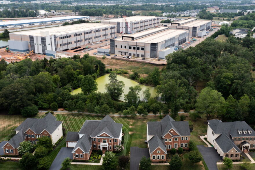 STONE RIDGE, VIRGINIA - JULY 17: In an aerial view, an Amazon Web Services data center is shown situated near single-family homes on July 17, 2024 in Stone Ridge, Virginia. Northern Virginia is the largest data center market in the world, according to a report this year cited in published accounts, but is facing headwinds from availability of land and electric power.
