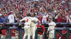 Philadelphia Phillies' Nick Castellanos (8) celebrates with Bryce Harper after hitting a home run against New York Mets pitcher Luis Severino during the sixth inning of Game 2 of a baseball NL Division Series, Sunday, Oct. 6, 2024, in Philadelphia. (AP Photo/Chris Szagola)
