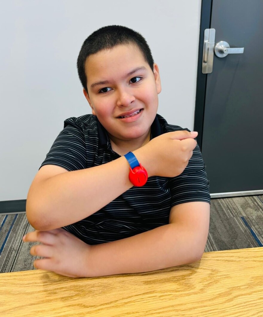 One of the Project Lifesaver participants in Schuyler shows off his transmitter bracelet.