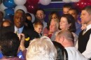 Family and friends surround Sly James during his victory speech.