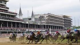 Javier Castellano, atop Mage, third from left, is seen with others behind the pack as they make the first turn while competing in the 149th running of the Kentucky Derby horse race at Churchill Downs in 2023. (Julio Cortez/AP)