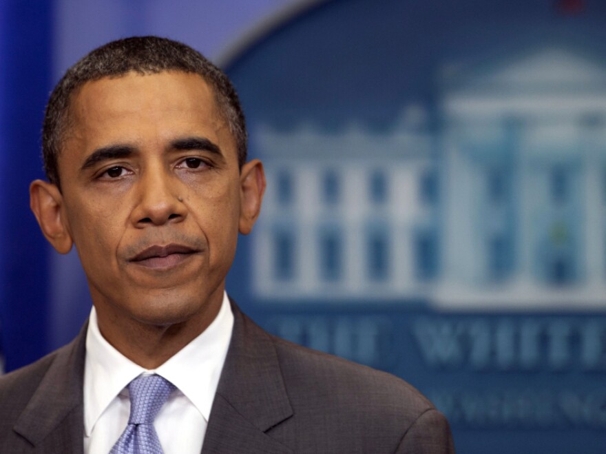 President Barack Obama pauses as he speaks from White House briefing room, Sunday, July 31, 2011 in Washington, about a deal being reached to raise the debt limit.