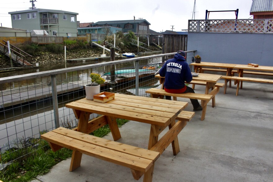 A local resident sits outside Falafelove to enjoy his meal
