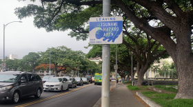 FILE - A sign indicates the border of the tsunami evacuation zone as traffic also forms in the background amid a tsunami warning. (July 29, 2025)
