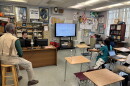 C.B. Hanif's classroom at Inlet Grove Community High School, where student reporters are combining their articles into one story. Hanif, left, offers nuggets of wisdom, like: "Editorial writing is the art of knowing what to leave out."