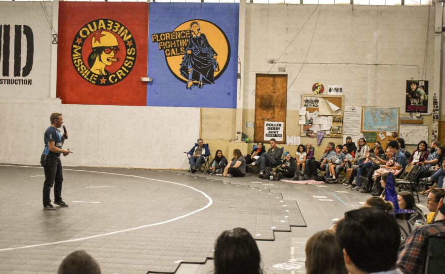 Pioneer Valley Roller Derby board co-chair Alex Kapitan (aka Peter Pandemonium) speaks to the crowd on Sept. 14, 2019, at The Bunker.