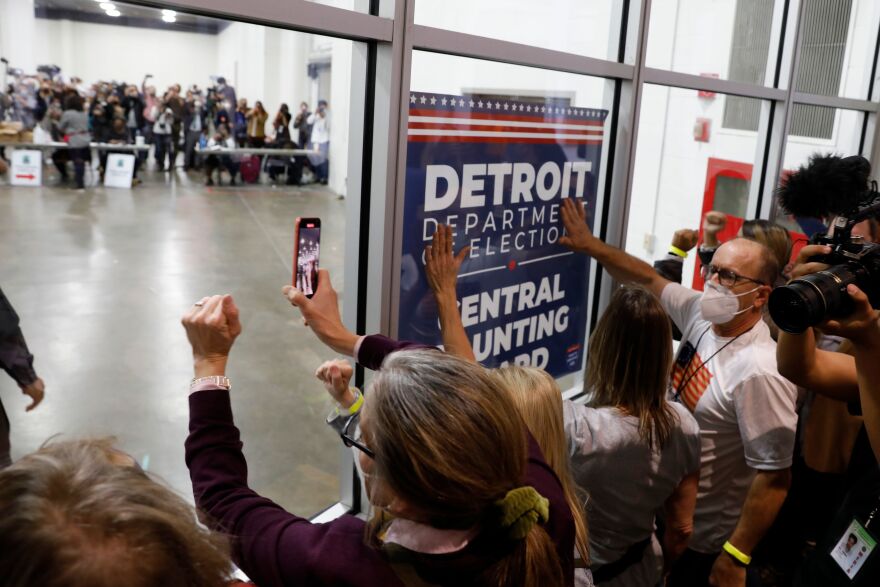 Supporters of President Trump bang on the glass and chant slogans outside the room where absentee ballots for the 2020 general election were counted at TCF Center on November 4, in Detroit, Mich.