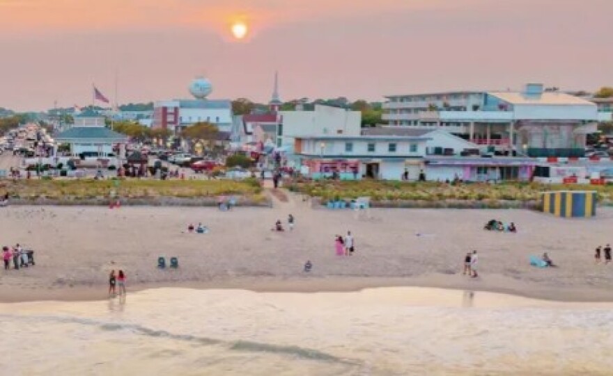 The cover photo from the 2026 Visit Delaware Travel Guide features an aerial sunset view of the beach and Boardwalk at Rehoboth Beach.