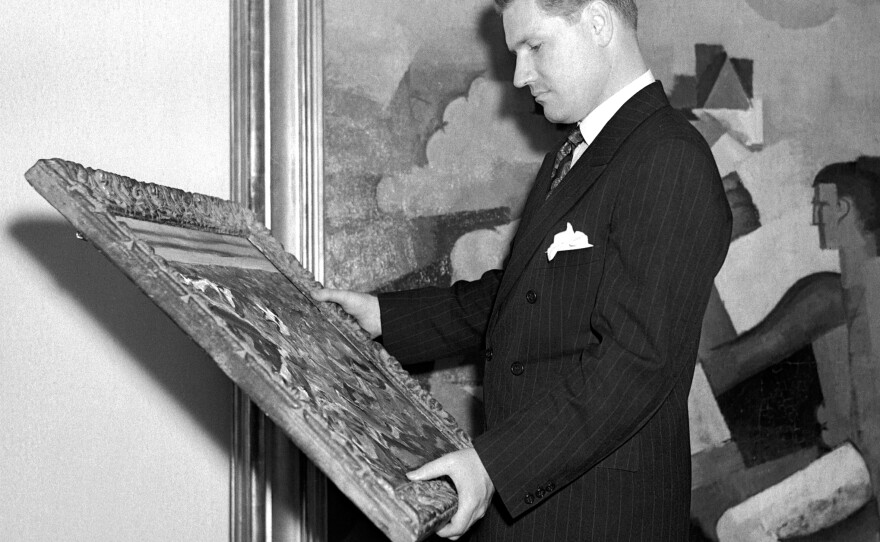 Nelson Rockefeller examines a painting at New York's Museum of Modern Art in 1939. Rockefeller was 23 when he hired Diego Rivera to paint a mural in the newly built Rockefeller Center.