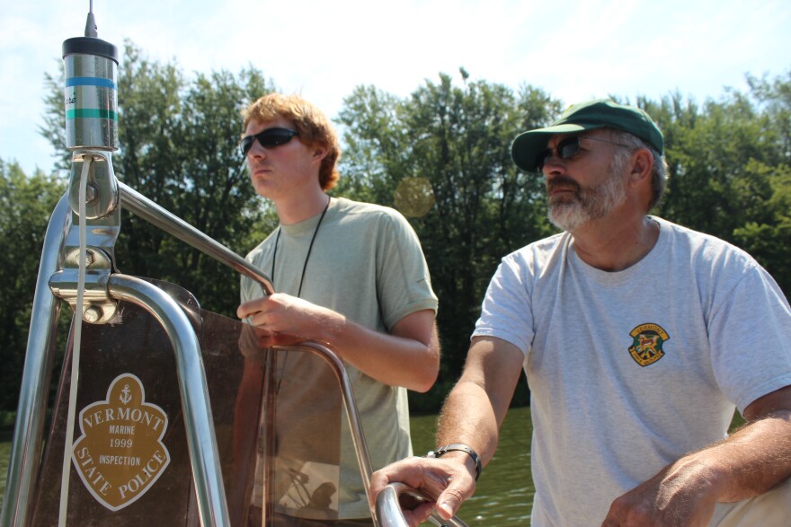 Chet MacKenzie and Tyler Brown, with the Department of Fish and Wildlife, motor up the mouth of the Winooski River.