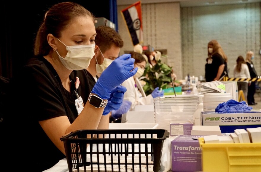 Pharmacy Tech Madison Wilmes fills syringes with the coronavirus vaccine at Christian Hospital on March 4, 2021.                   