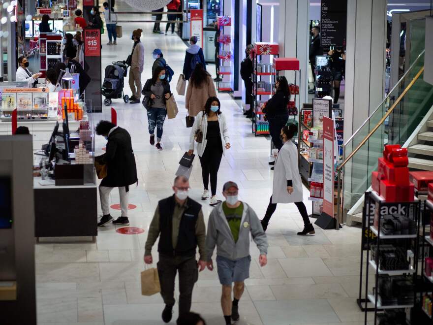 Shoppers walk through Macy's in New York on Black Friday last month. Retail sales declined 1.1% in November, according to the Commerce Department.