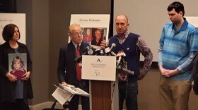 Darin Buckman addresses reporters about the alleged abuse he encountered as a child as he stands with attorney Jeff Anderson and plaintiffs Cynthia Yesko and Joshua Bollman (right).