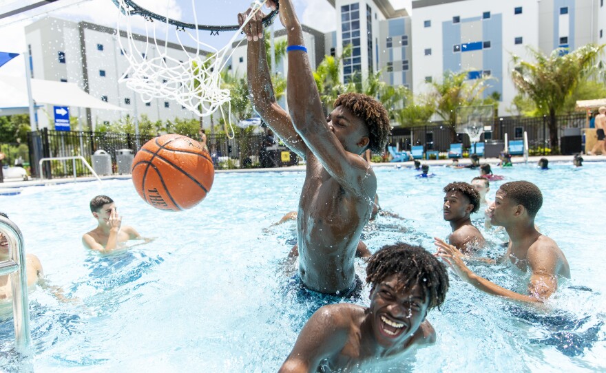 students playing water basketball
