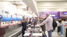 Passengers at the El Paso International Airport check on the status of their flights amid a temporary flight restriction for El Paso airspace. The TFR will last for 10 days, according to a notice from the Federal Aviation Administration.