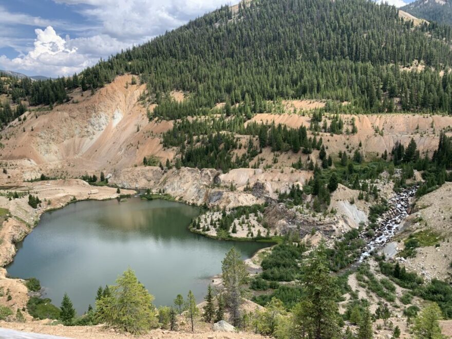 An overhead view of the abandoned Yellow Pine Pit at the Stibnite Mine, which Perpetua Resources hopes to resume mining in. (Clark Corbin/Idaho Capital Sun)