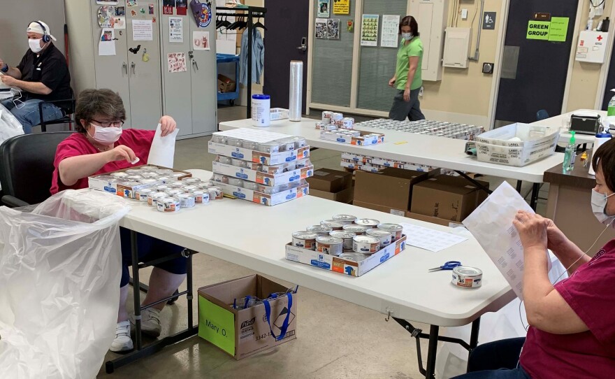 Workers at Cottonwood assemble pet food variety packs as part of their employment services.