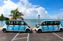 Two small three-door vehicles plastered with St. Pete Beach logos and messaging.