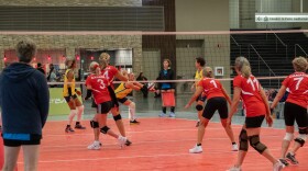 shot of a volleyball point being played in a game between Canada and Brazil