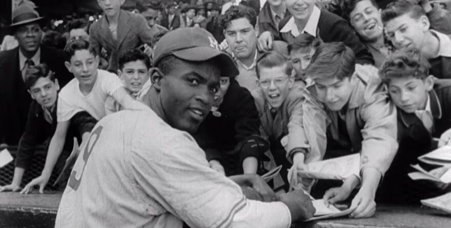 Jackie Robinson signs autographs 
