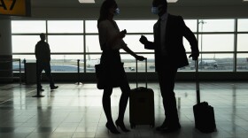 People talking inside of an airport. (Getty Images)