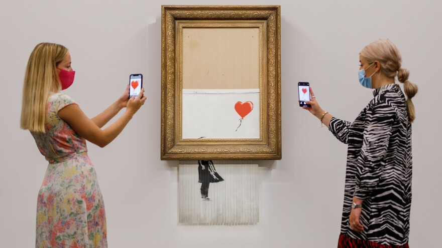 Banksy's "Love is in the Bin" (2018) is installed at Sotheby's on Sept. 3, in London. On Thursday it was auctioned for $25.4 million, a record for the artist.