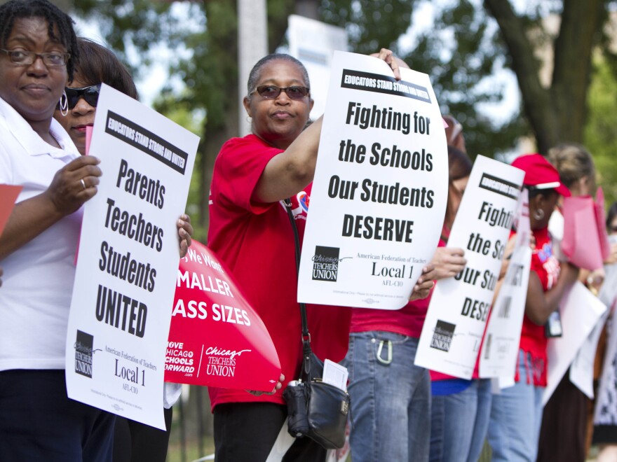 Members of the Chicago Teachers Union hold an informational picket outside Willa Cather Elementary School on Aug. 20 in Chicago. Teachers could go on strike Monday.