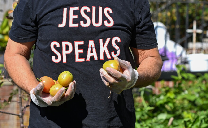 Everett Upton of Common Ground Ministries picks vegetables in the garden at the church.