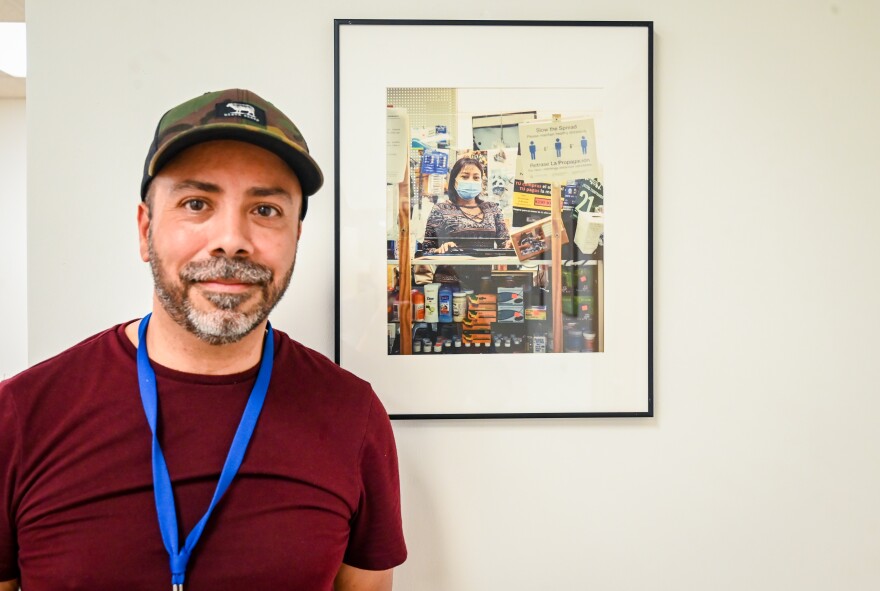 Héctor Vaca Cruz poses with one of the images he has on display for Los Fotógrafos.