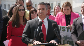 U.S. Senator Ben Ray Lujan speaks to the crowd Wednesday at RECA rally in Washington. NM Rep. Teresa Leger Fernandez stands to his left.