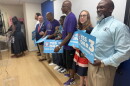 Kelvin Manurs, right, joins with Senator Elizabeth Bennett-Parker and other supporters of Amendment 3 at a press conference in Alexandria Tuesday.