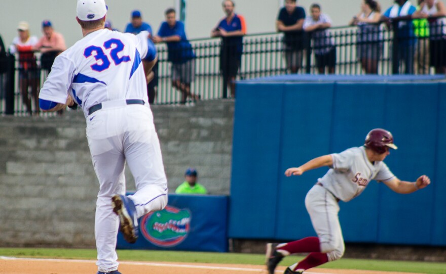 Pitcher Logan Shore throws to first base on an attempt to capture runner Josh Delph, Friday, June 5, 2015.