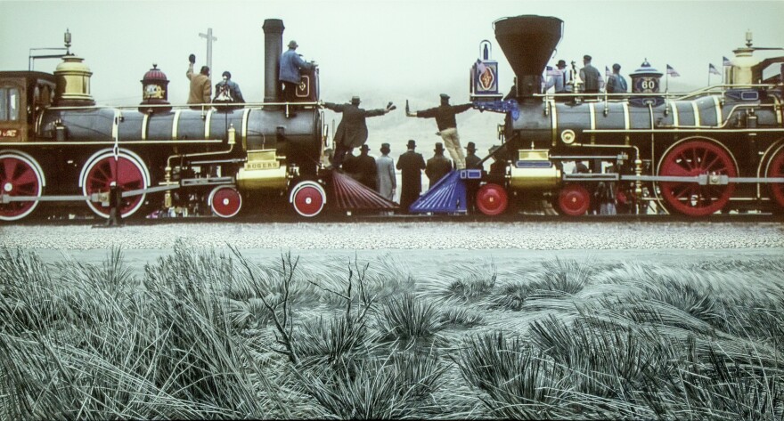 An artistic portrayal of two trains meeting at the completion of the railroad as people cheer and celebrate. 