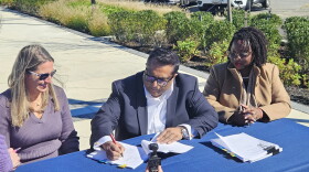 CWDI President Angie Hengst, Pinnacle Hospitality Group President Tauhid Islam and Cambridge Mayor Lajan Cephas Bey sign the Cambridge Harbor hotel agreement